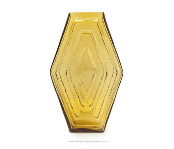The Infinite Hexagon Vase Large is a striking appearance of 30 cm high, made of amber-coloured recycled glass.